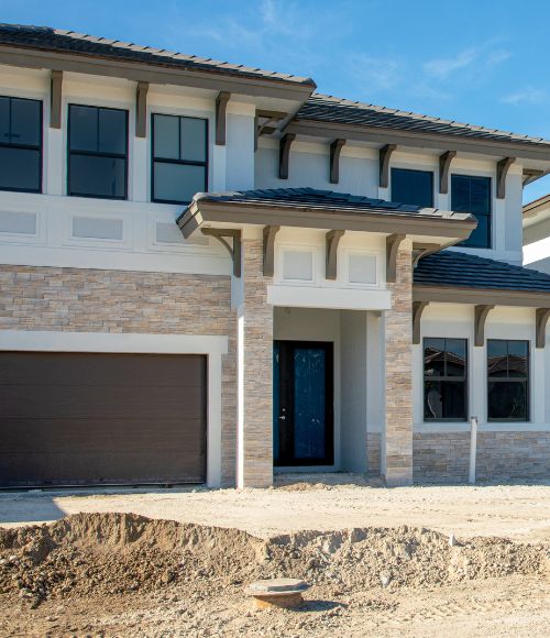 new two story house with faux stone being built in Yuma suburb
