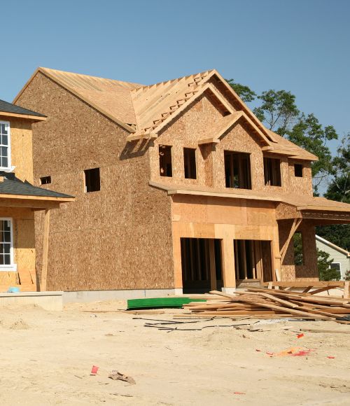 two-story house under construction finished framing